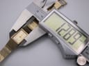 Digital caliper measuring the width of the watch case, displaying 12.89mm on the screen.