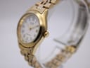 Angled side view of the Citizen watch, showing the crown and polished gold-tone case.
