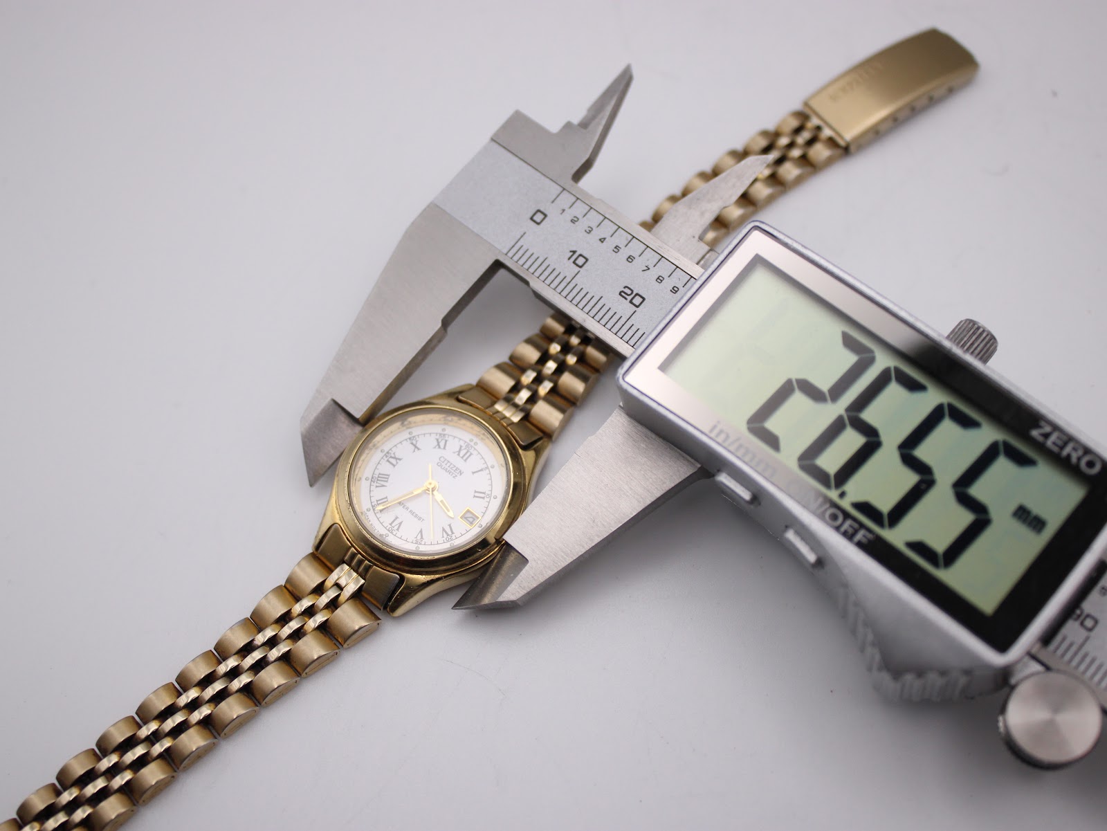 Top-down view of the Citizen watch, with a digital caliper measuring the case diameter at 26.55mm.