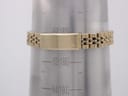 Close-up of the gold-tone Citizen steel bracelet on a wrist sizing gauge, showing the signed fold-over clasp and an approximate wrist circumference of 183mm.