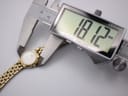 Digital caliper measuring the case diameter of the Citizen watch, displaying 18.12mm.