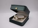The pre-owned Citizen watch nestled inside its original dark green presentation box with a cream interior.