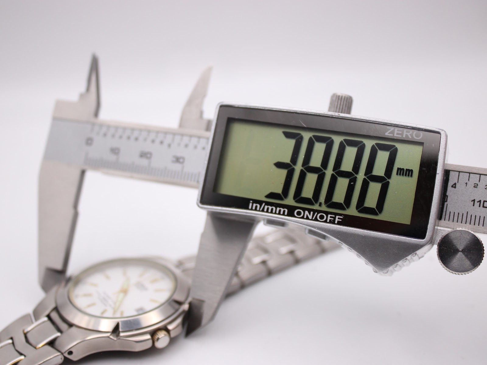 Close-up of a digital caliper measuring the watch case, displaying an exact diameter of 38.88mm.