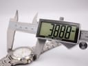 Close-up of a digital caliper measuring the watch case, displaying an exact diameter of 38.88mm.