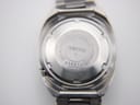 Close-up of the stainless steel case back of the Seiko 6119-8273, displaying model 6119-8273, serial number 232270, and 'Water Resistant Japan A' engravings.