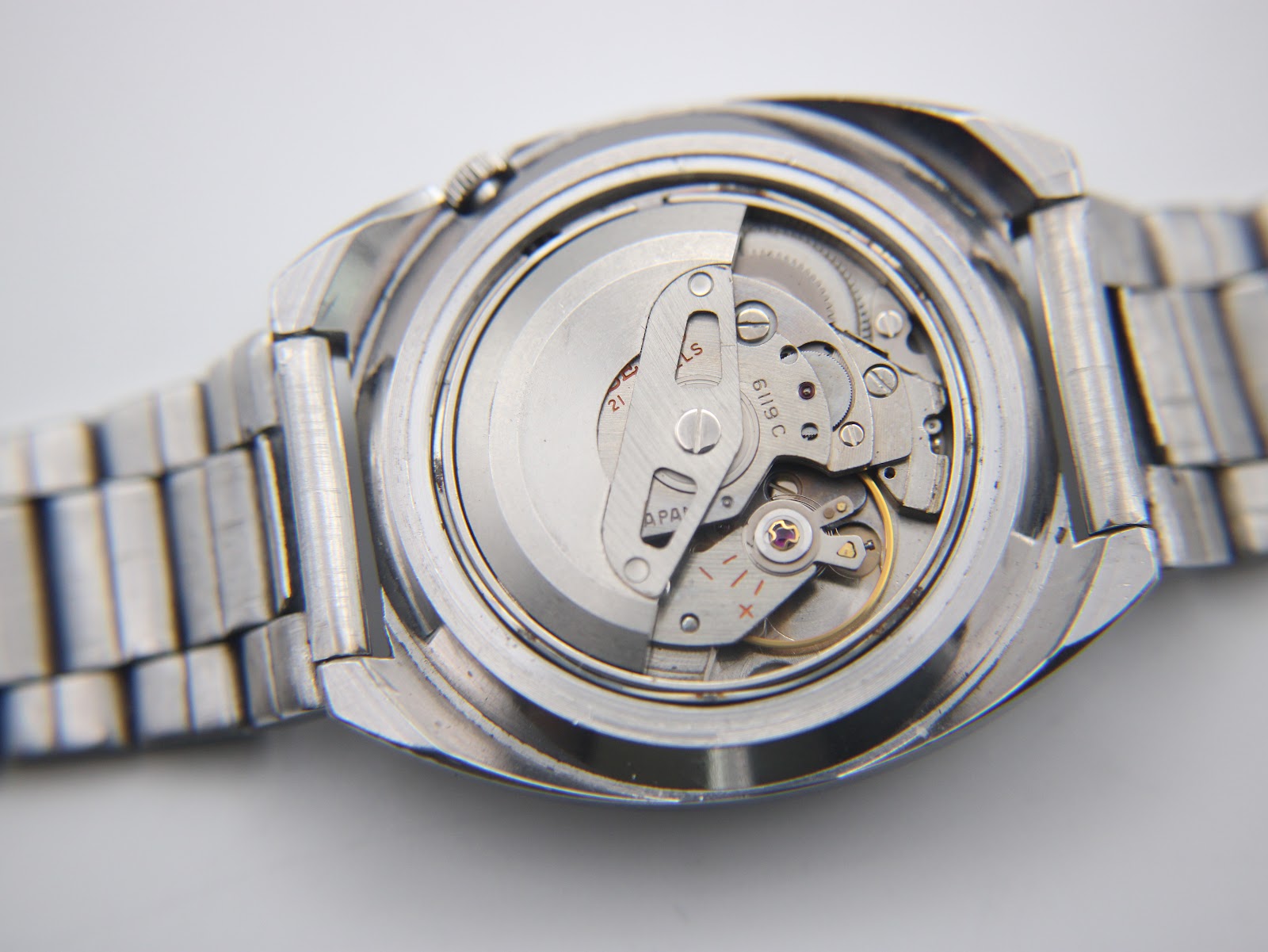 Another close-up of the opened case back, showing more of the intricate Seiko 6119C automatic movement.