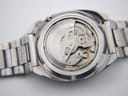 Another close-up of the opened case back, showing more of the intricate Seiko 6119C automatic movement.