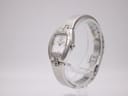 Angled side view of the Tissot L953 watch on a display stand, showing the tonneau case and bracelet.