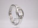 Another angled side view of the Tissot L953 watch, highlighting the polished stainless steel and diamond detailing.