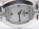 Detailed close-up of the mother of pearl dial, showing the Tissot logo, simple indices, and diamond accents on the case.