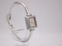Another angled view of the Gucci 1900 L watch, highlighting the case and the continuous bangle design.