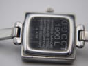 Close-up of the polished stainless steel case back of the Gucci 1900 L, showing model number, serial, and water resistance.