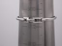 Rear view of the Gucci 1900 L bangle bracelet on a wrist sizing cone, showing the concealed clasp and wrist measurement lines.
