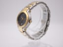Angled side view of the Gucci 8900L watch on a stand, showing the two-tone case and crown.