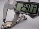 Digital caliper measuring the case diameter of the watch, displaying 24.81mm.