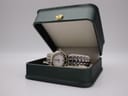 The Maurice Lacroix watch displayed in an open dark green presentation box.