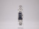 Front view of the Gucci 110 women's quartz watch with a blue rectangular dial and integrated silver bracelet.