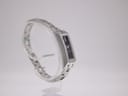 Angled view of the Gucci 110 watch on a display stand, showing the integrated bracelet.