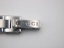 Close-up of the deployant clasp on the Gucci 110 bracelet, clearly showing the 'GUCCI' engraving.
