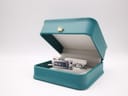 The Gucci 110 watch resting inside a teal watch display box (box is for display, not included).