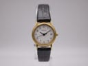 Front view of the Tissot C 212 ladies' watch on a display stand, showing the gold-tone case, white dial with Arabic numerals, and black leather strap.