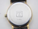 Close-up view of the Tissot C 212 stainless steel case back, showing the 'T' logo, model number, water resistance, and sapphire crystal engraving.