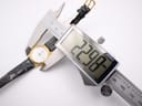 Close-up of a digital caliper measuring the Tissot C 212 watch case diameter at 22.98mm.