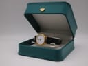 The Tissot C 212 watch nestled inside its original teal Tissot presentation box.