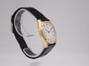 Another angled side view of the Seiko watch, highlighting the curvature of the tonneau case and the texture of the strap.