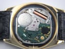 Detailed view of the Seiko quartz movement inside the watch case, showing the battery and internal components.