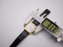 A digital caliper measuring the case width of the Seiko watch, displaying a precise measurement of 31.0 mm.