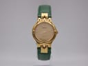 Front view of the gold Tissot Stylist watch with a gold dial and green leather strap, on a light background.