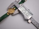 Top-down view of the Tissot Stylist watch being precisely measured by a digital caliper, displaying a case size of 25.79mm.