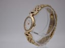 Angled side view of the Raymond Weil 5889 watch, showing the oval gold-tone case, crown, and integrated gold-tone bracelet.