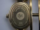 Close-up of the watch case back, showing 'RAYMOND WEIL', model 5889, serial, 18k gold electroplated, 3ATM water resistant, and sapphire crystal markings.