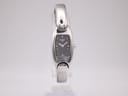 Front view of the Tissot G345 ladies' watch with a black oval dial and integrated silver-tone bangle bracelet.