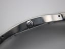 Close-up of the Tissot G345 watch crown, showing the Tissot 'T' logo.