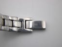 Close-up of the Tissot G345 bracelet clasp, displaying the Tissot 'T' logo and minor surface wear.