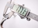 Digital caliper measuring the Tissot G345 watch case diameter, showing a precise reading of 17.7mm.