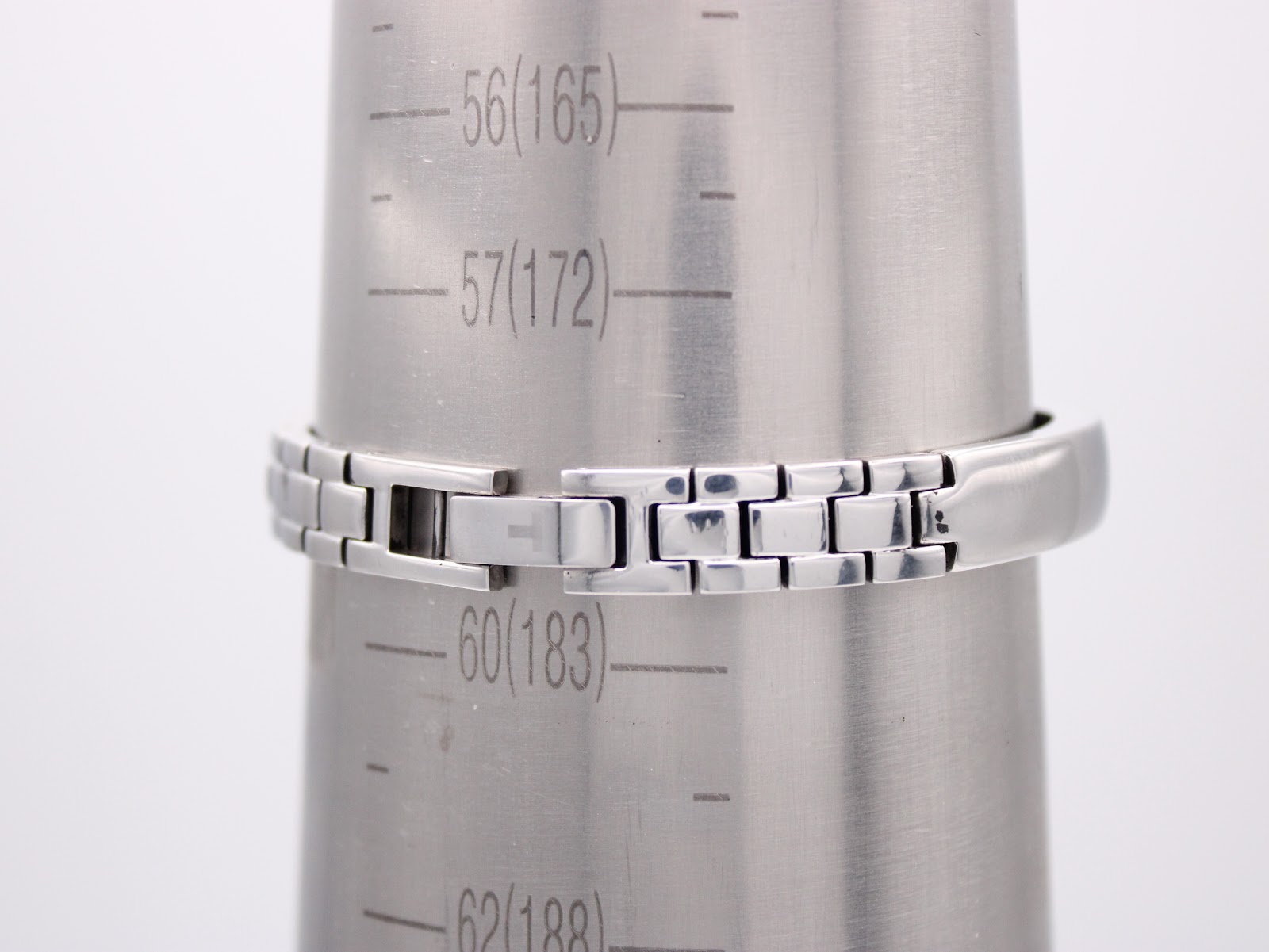 The Tissot G345 integrated bangle bracelet on a wrist sizing gauge, showing an internal circumference of 183mm.