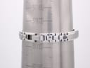 The Tissot G345 integrated bangle bracelet on a wrist sizing gauge, showing an internal circumference of 183mm.
