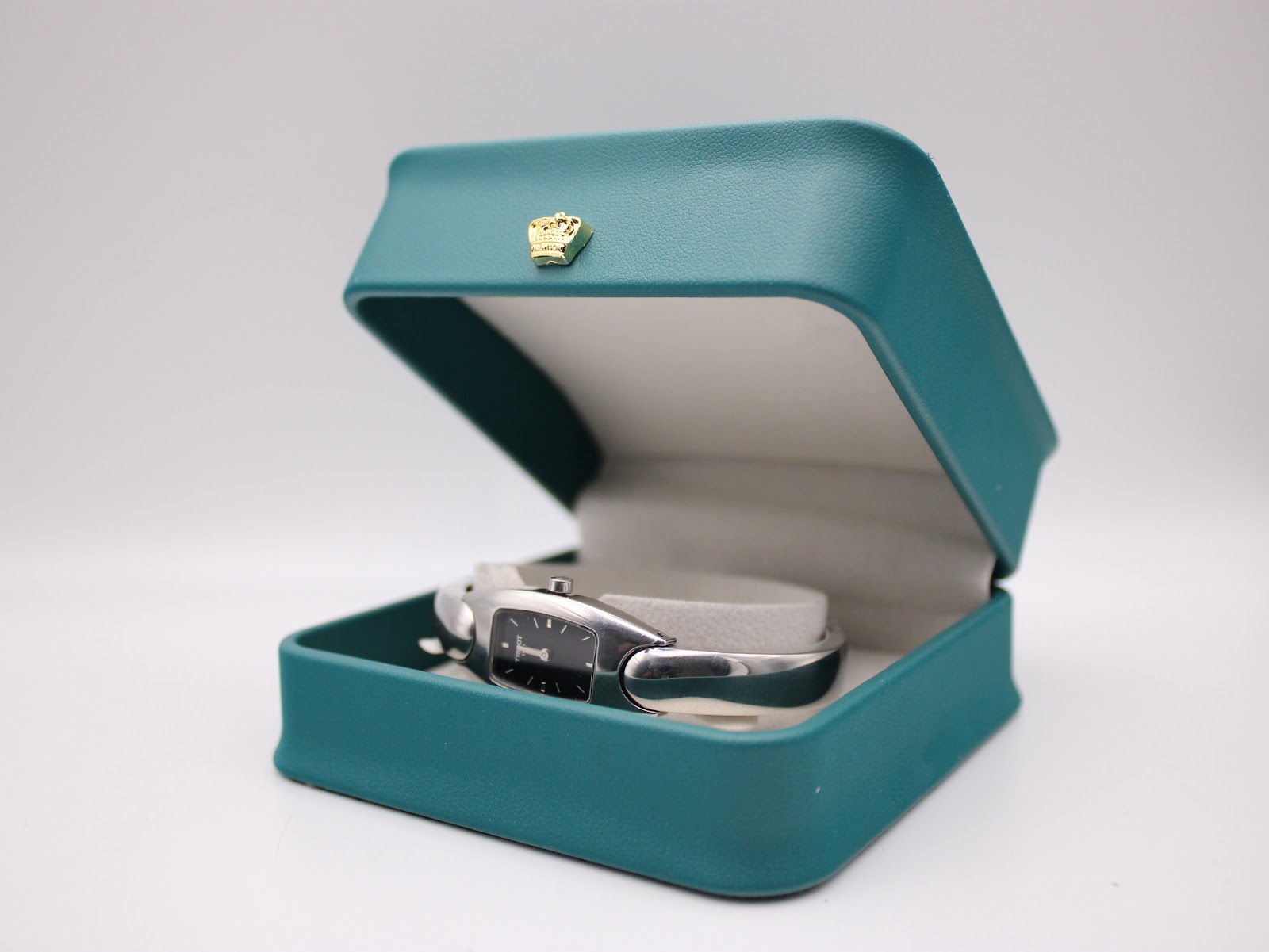 The Tissot G345 watch displayed inside an open turquoise presentation box, providing context for size.
