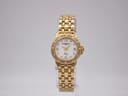 Front view of the gold-plated Raymond Weil Tango watch on a clear stand, showing its mother of pearl dial and crystal-set bezel.