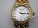 Detailed close-up of the Raymond Weil Tango mother of pearl dial, with gold Roman numerals, crystal hour markers, gold hands, and the 'Tango' script.