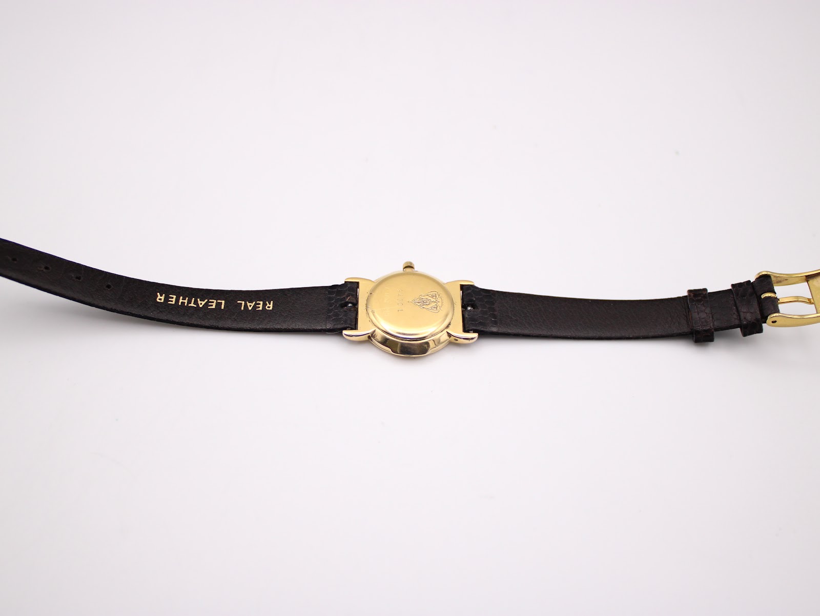 Full length back view of the Gucci 3400 L watch showing the case back and the "REAL LEATHER" marked strap.