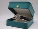 The Gucci 3400 L watch placed inside a teal display box with a gold crown emblem.