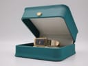 The Michel Herbelin watch displayed within an open teal presentation box.