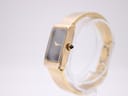 Angled side view of the Michel Herbelin watch showing the gold tone case and crown with a black cabochon detail.