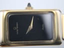 Close-up of the rectangular black dial with 'michel herbelin Paris' in gold text and pointed gold hands.