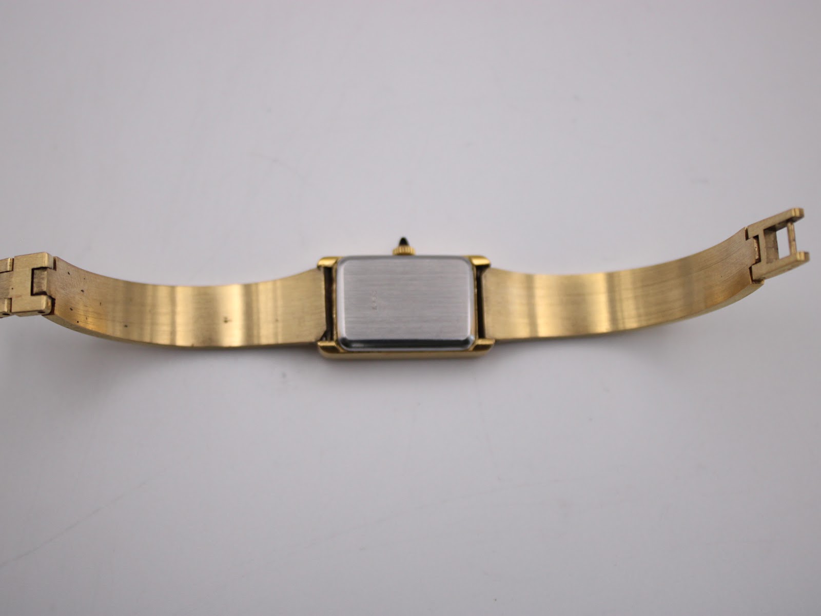 Rear view of the Michel Herbelin watch, showing the case back and extended integrated bracelet.